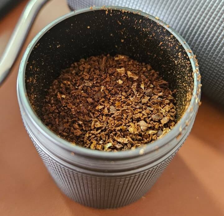 Compartimento do moedor de café iCoffee cheio de pó de café.